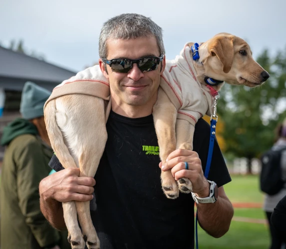 Michael with a dog at an outdoor event